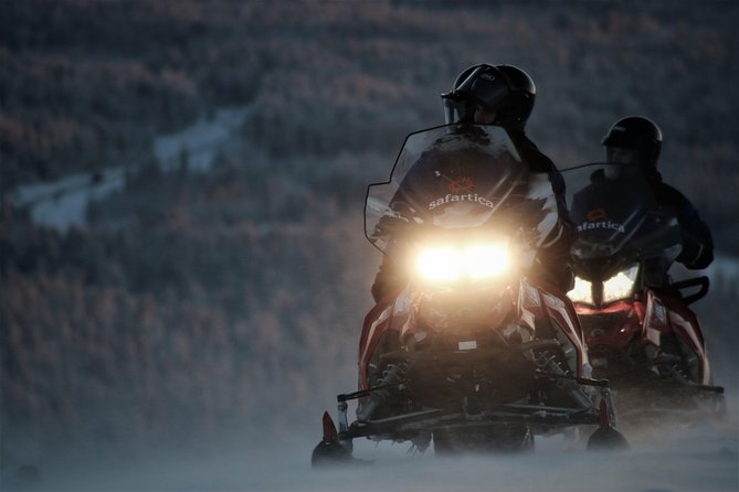 Evening Escape - Snowmobile safari and campfire in Rovaniemi - Riding into Rovaniemi’s dark Arctic woods