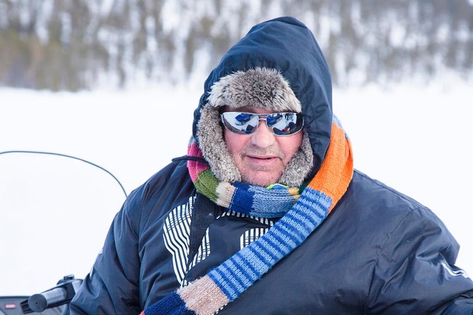 From Ivalo: Ice Fishing Safari to Lake Inari, reindeers & lunch - Fishing through the ice on Lake Inari