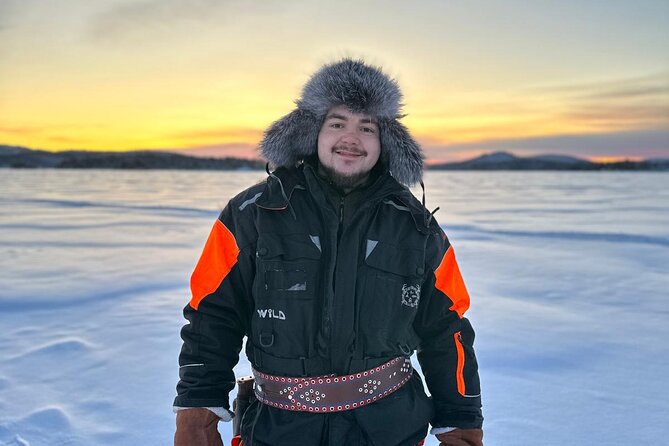 From Saariselkä: Ice Fishing Tour to Lake Inari, reindeers &lunch - Riding a snowmobile-pulled sled across the lake