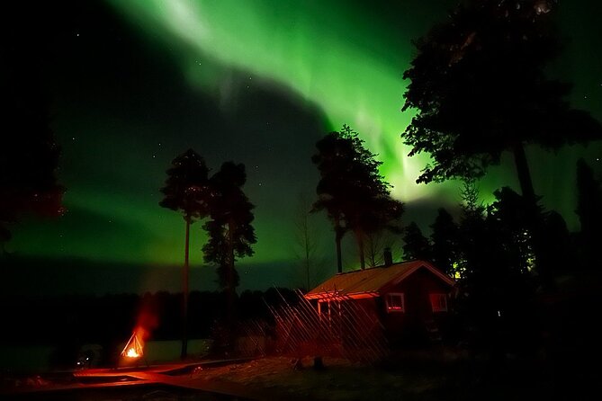 Glass Igloo Campfire Dinner under Northern Lights - A campfire dinner beneath the Arctic sky