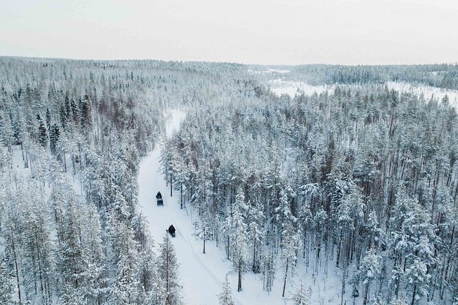Ice Fishing and Snowmobile Safari Combo in Lapland - Drilling a hole in the frozen lake