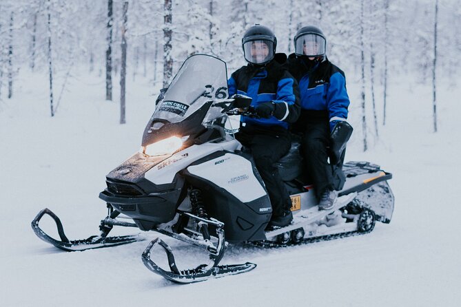 Ice Fishing by Snowmobile in Levi - Drilling through the ice changes the pace