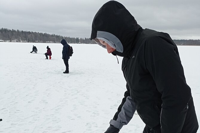 Ice fishing experience with Backpacker Helsinki Tour - Reaching the frozen lake and getting ready to fish
