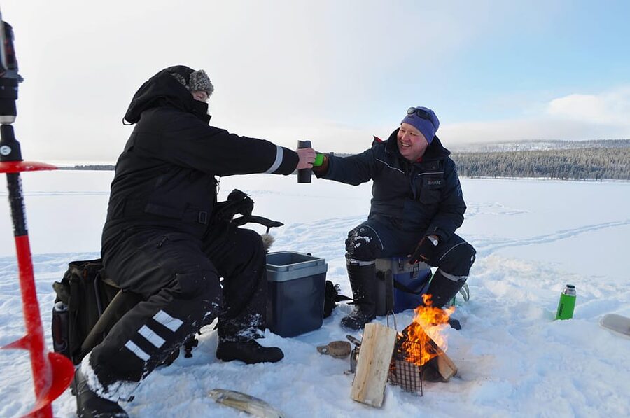 Ice fishing program in Lapland - Fire, food, and a proper winter warm-up