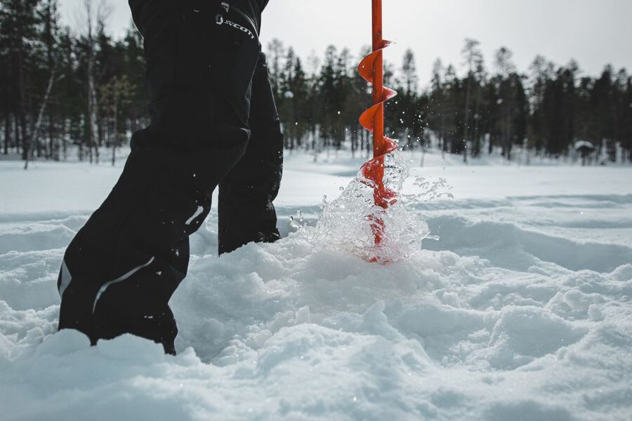 Levi: Finnish Ice Fishing Tour by Car - Drilling your own hole and learning the gear