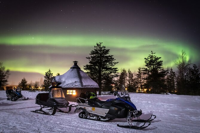 Levi Northern lights by snowmobile - Riding through the moonlit forest