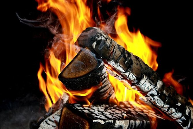 Northern Lights Snowmobile Hunt - A campfire in the dark