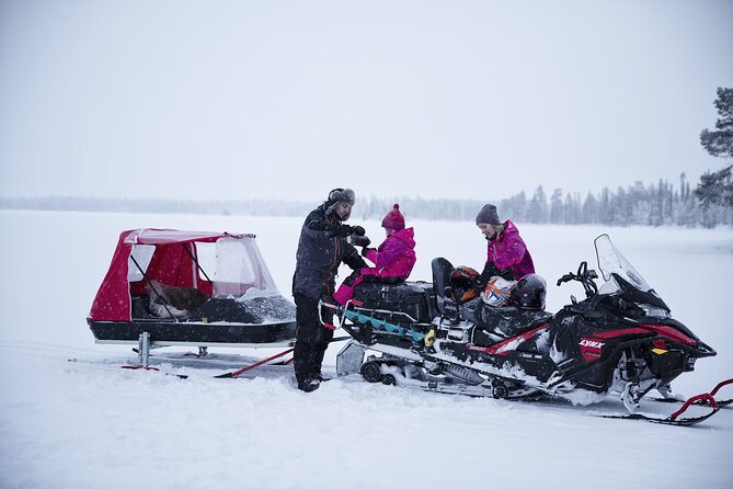 Northern Lights Snowmobile Sledge Ride in Rovaniemi - Snowy forest scenery under a changing sky