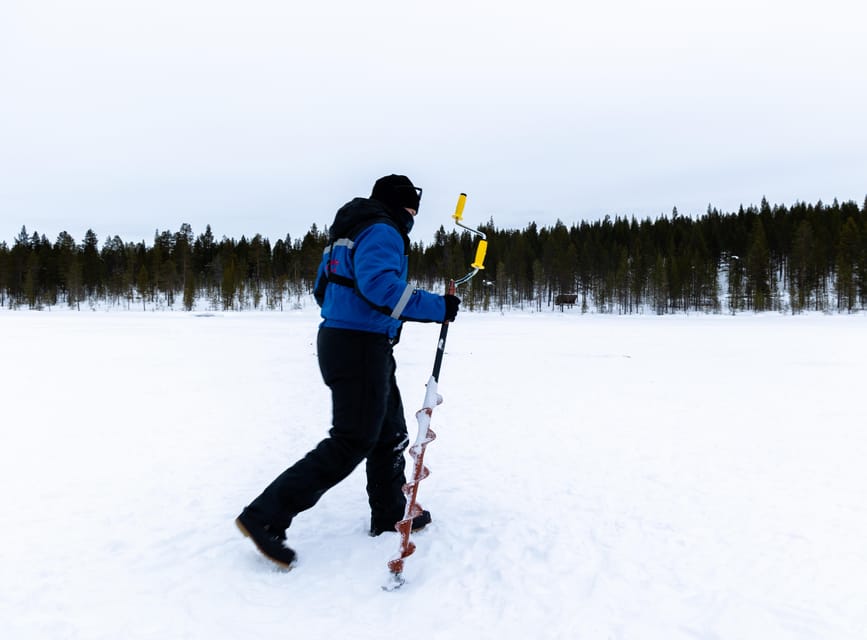 Saariselkä: Ice Fishing Safari by Snowmobile - Drilling through the frozen lake